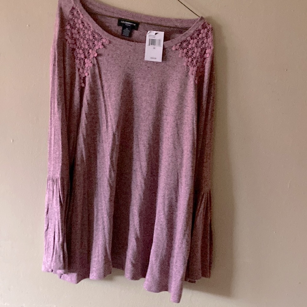 Pink sweater with black print.